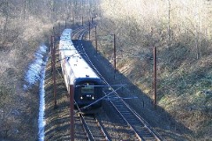 Ic3 trainset MFA 5043/MFB 5243 (named Ole Bendix). Photographed in Middelfart, 19. March 2005.  The Ic3 was built by ABB Scandia in Denmark. Each unit consists of 3 coaches. Built in a number of 92 trainsets. The trainsets were put in service in 1989 - 1998. 4 diesel engines of 294 kW per trainset. Max speed 180 km/h - 112 mph. Length 58 800 mm. Weight 97 metric tonnes. 16 seats 1st class, 128 seats 2nd class. Up to 5 trainsets can be put together. The MFA 5043/MFB 5243 was put in service in 1991.