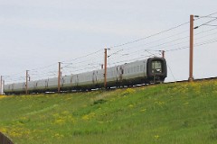 Ic3 trainset MFA 5009/MFB 5209 (named Torsten) photographed at the ramp to Storebæltsbroen 30. May 2005.  The Ic3 was built by ABB Scandia in Denmark. Each unit consists of 3 coaches. Built in a number of 92 trainsets. The trainsets were put in service in 1989 - 1998. 4 diesel engines of 294 kW per trainset. Max speed 180 km/h - 112 mph. Length 58 800 mm. Weight 97 metric tonnes. 16 seats 1st class, 128 seats 2nd class. Up to 5 trainsets can be put together. The MFA 5049/MFB 5249 was put in service in 1990.