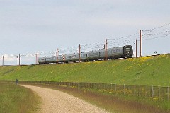 DSB Ic3 trainset MFA 5021/MFB 5221 (named Hærulf) photographed at the ramp to Storebæltsbroen 30. May 2005.  The Ic3 was built by ABB Scandia in Denmark. Each unit consists of 3 coaches. Built in a number of 92 trainsets. The trainsets were put in service in 1989 - 1998. 4 diesel engines of 294 kW per trainset. Max speed 180 km/h - 112 mph. Length 58 800 mm. Weight 97 metric tonnes. 16 seats 1st class, 128 seats 2nd class. Up to 5 trainsets can be put together. The MFA 5049/MFB 5249 was put in service in 1990.