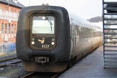 Ic3 trainset MFA 5027/MFB 5227 (named Peter Tordenskiold) photographed in Vejle 14. January 2007.  The Ic3 was built by ABB Scandia in Denmark. Each unit consists of 3 coaches. Built in a number of 92 trainsets. The trainsets were put in service in 1989 - 1998. 4 diesel engines of 294 kW per trainset. Max speed 180 km/h - 112 mph. Length 58 800 mm. Weight 97 metric tonnes. 16 seats 1st class, 128 seats 2nd class. Up to 5 trainsets can be put together. The MFA 5027/MFB 5227 was put in service in 1991.